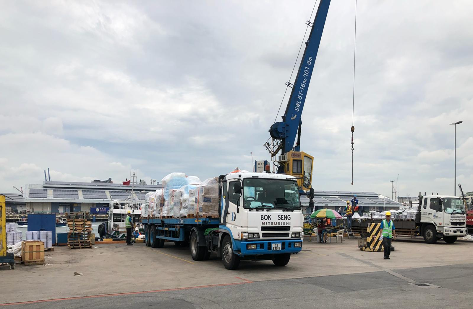 Crane loading ship supplies onto a truck at the quayside